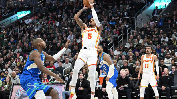 Atlanta Hawks guard Dejounte Murray (5) puts up a shot against Milwaukee Bucks forward Khris Middleton (22) in the second half at Fiserv Forum.